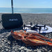 Aeroo Pro Drone on landing pad with fish caught and carry case with ocean in background