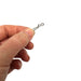 Hand holding a Gemini Genie Rig System link clip on a white background