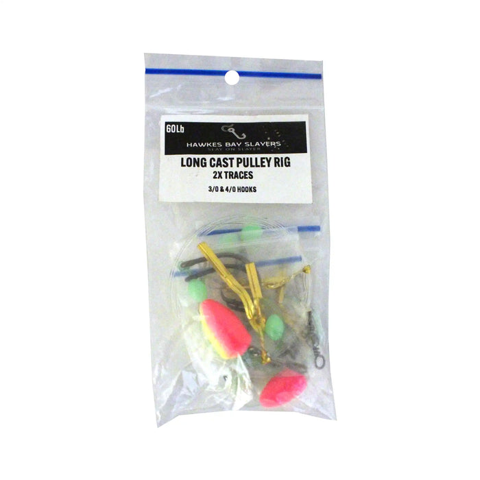 A clear plastic zip-top bag containing fishing lures, with a white printed label reading Hawkins Bay Slayers Long Cast Pulley Rig 2x Traces. The lures inside include gold metal hooks and bright pink, green, and white floats, photographed on a plain white background.