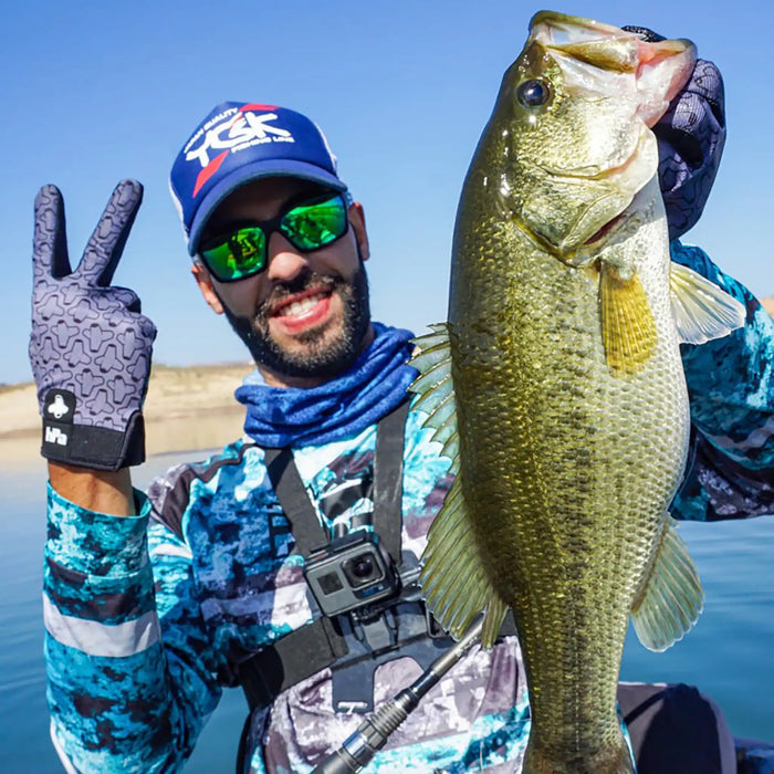 Man holding a large fish wearing hPa Tackmax Fishing Gloves