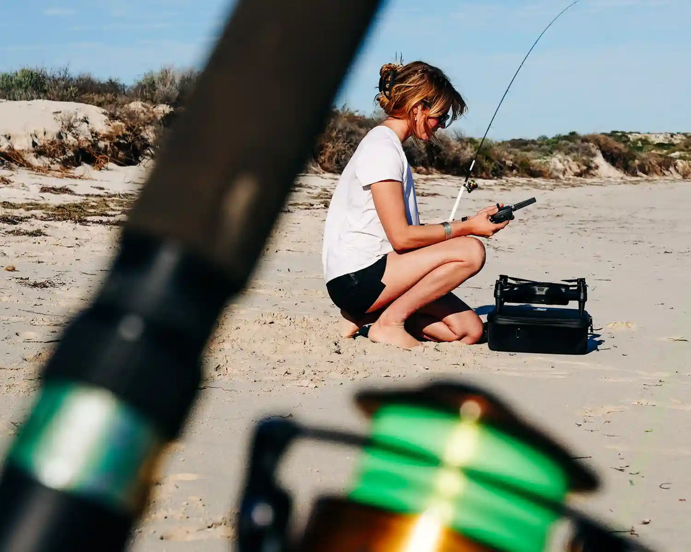 Surfcaster setting up Aeroo Drone for fishing on Beach